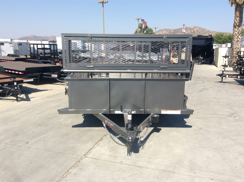 Front view of metallic charcoal landscape trailer with 2' solid metal sides, a full-width expanded metal box, weed eater racks, and tool storage